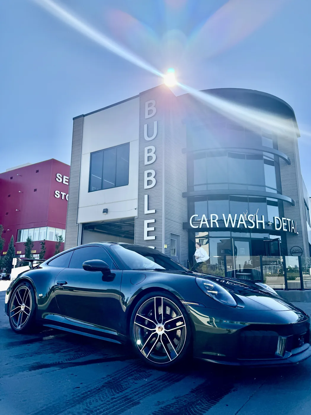 Freshly washed Porsche 911 gleaming at Bubbles